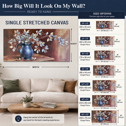 White flowering branches gathered in a deep blue pitcher against a warm rust-colored wall single canvas wall art size guide above a sofa; room view is illustrative