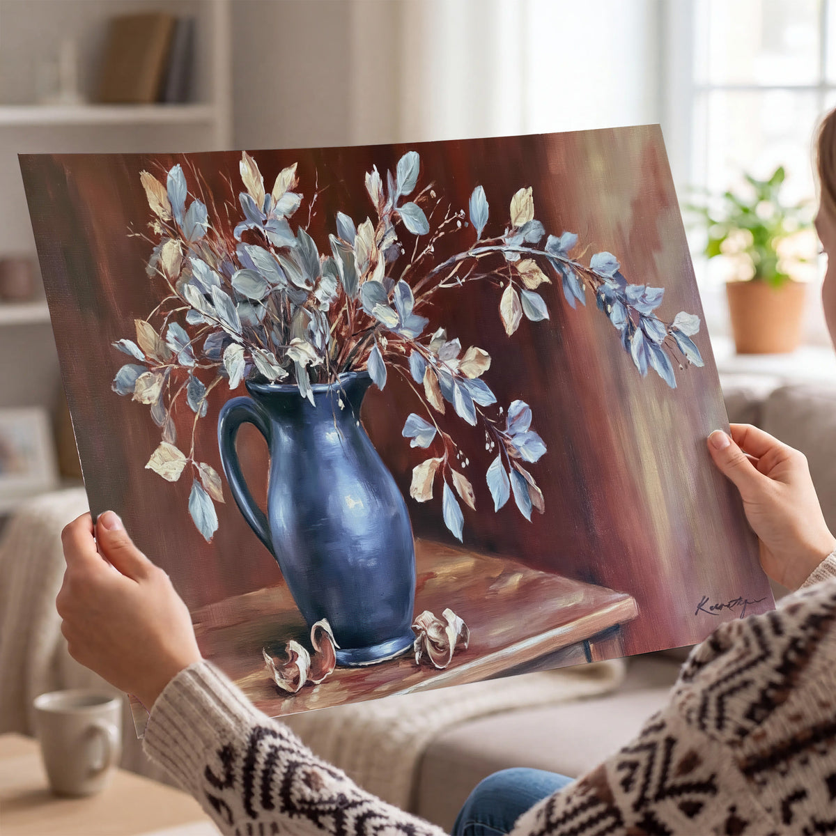 White flowering branches gathered in a deep blue pitcher against a warm rust-colored wall single poster print held in hands