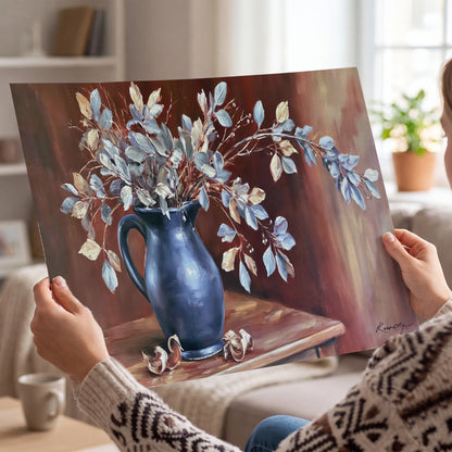 White flowering branches gathered in a deep blue pitcher against a warm rust-colored wall single poster print held in hands