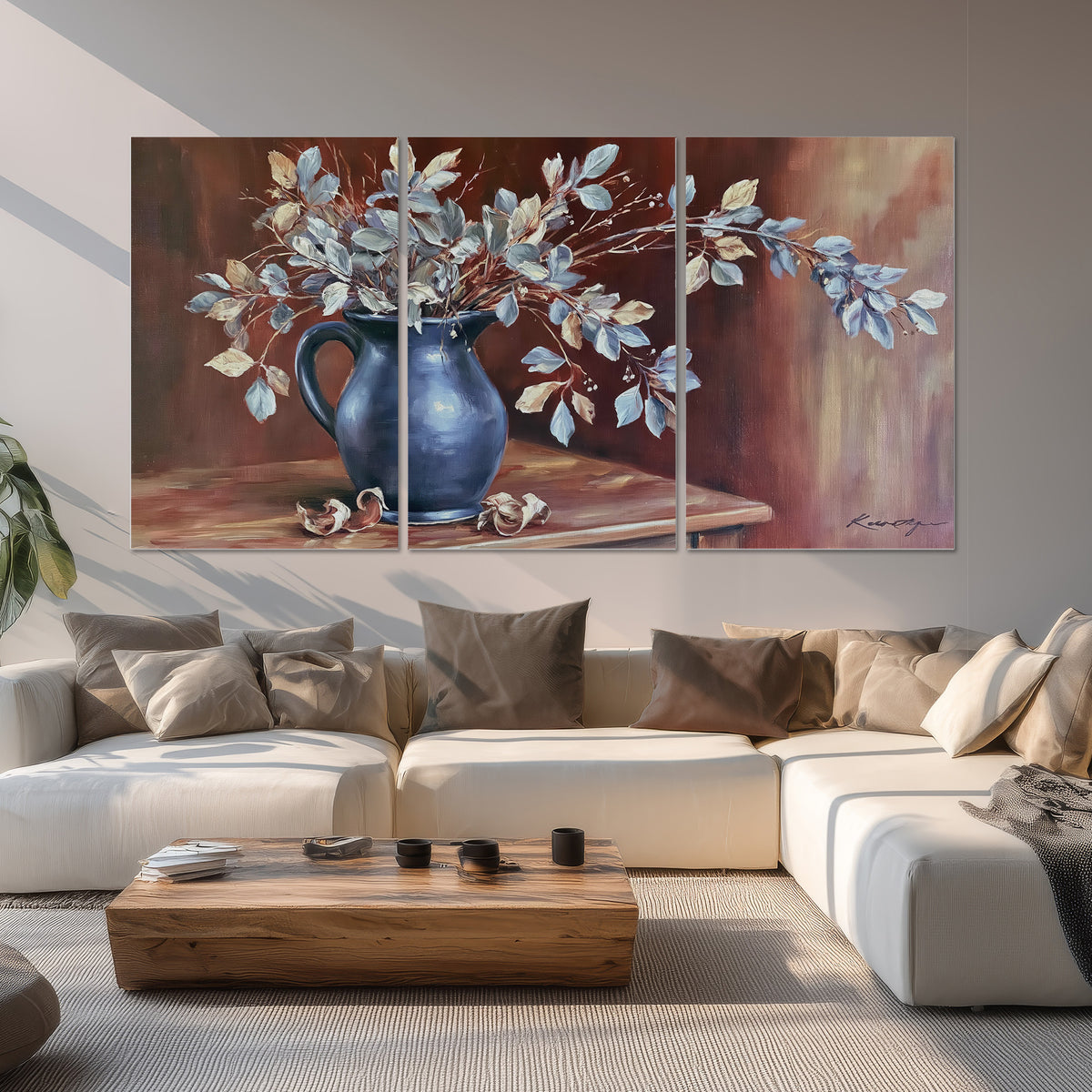 White flowering branches gathered in a deep blue pitcher against a warm rust-colored wall set of 3 poster prints displayed in a living room