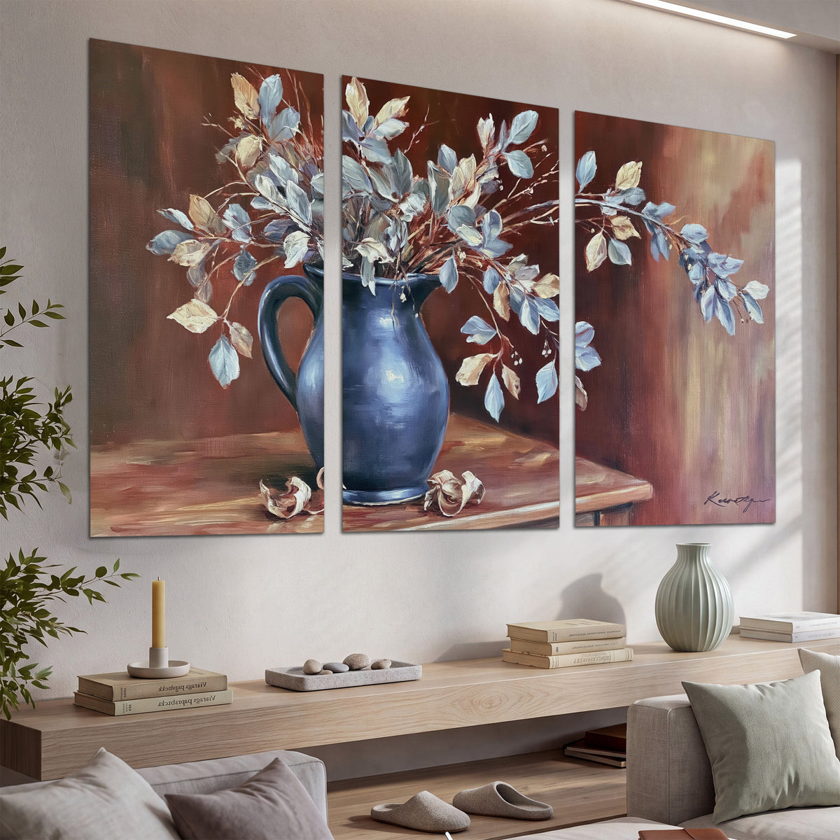 White flowering branches gathered in a deep blue pitcher against a warm rust-colored wall set of 3 poster prints displayed in a console