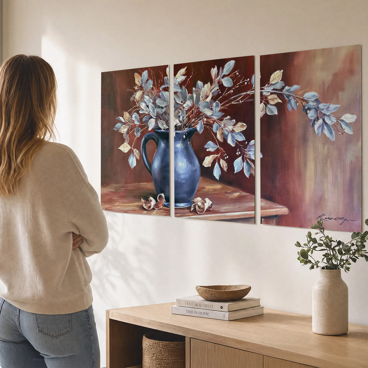White flowering branches gathered in a deep blue pitcher against a warm rust-colored wall set of 3 poster prints three panel arrangement on a wall