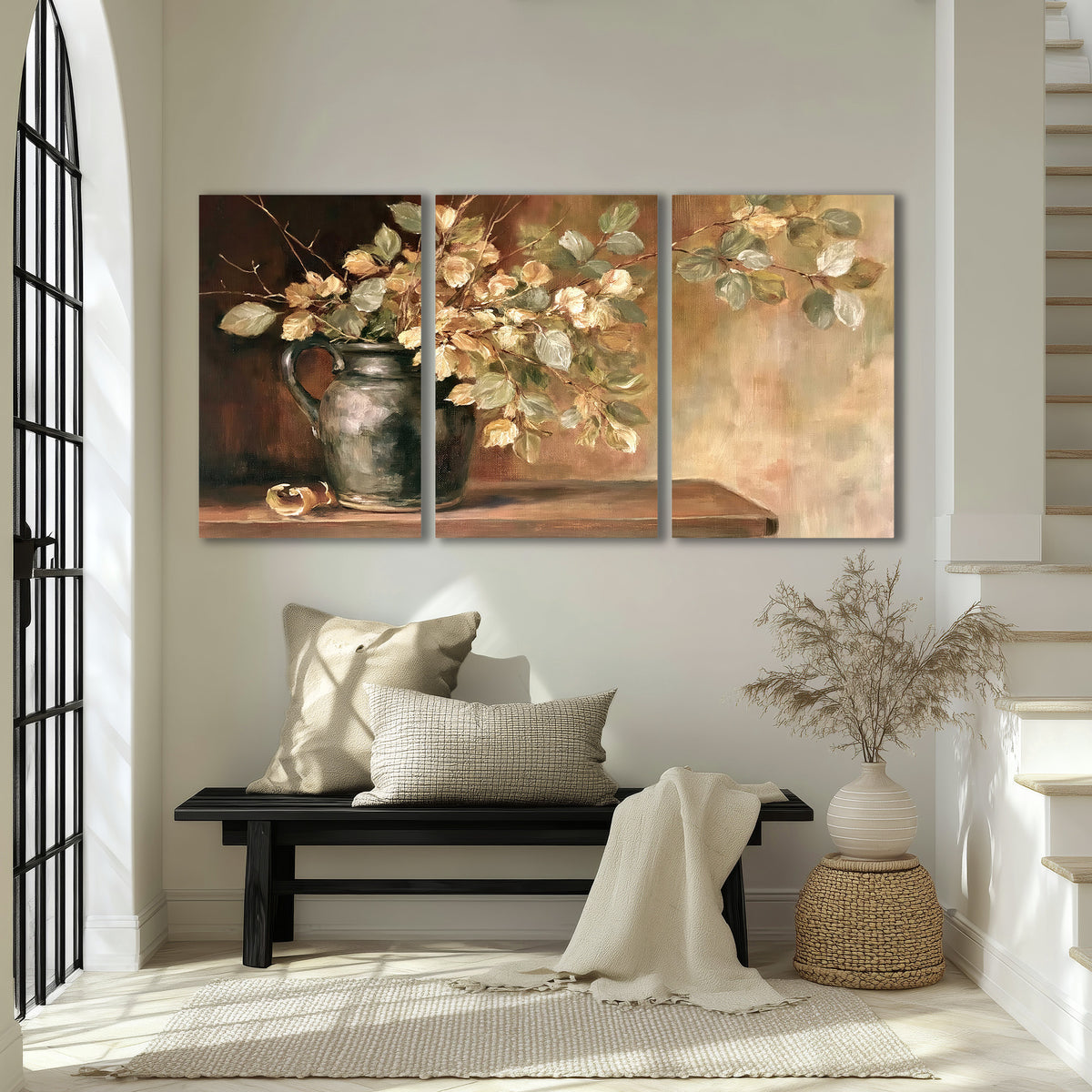 Pale golden blossoms and leaves in a dark green vase on a wooden ledge 3 piece canvas wall art displayed in a entryway
