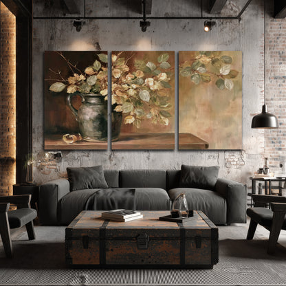 Pale golden blossoms and leaves in a dark green vase on a wooden ledge 3 piece canvas wall art displayed in a industrial room