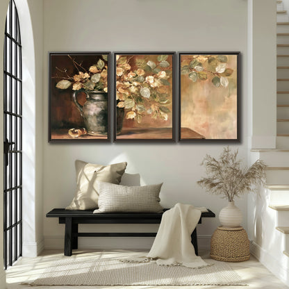 Pale golden blossoms and leaves in a dark green vase on a wooden ledge 3 piece framed canvas wall art displayed in a entryway