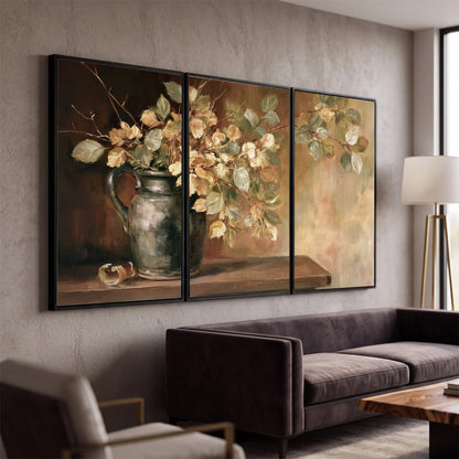 Pale golden blossoms and leaves in a dark green vase on a wooden ledge 3 piece framed canvas wall art displayed in a modern living room