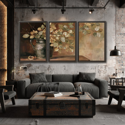 Pale golden blossoms and leaves in a dark green vase on a wooden ledge 3 piece framed canvas wall art displayed in a industrial room