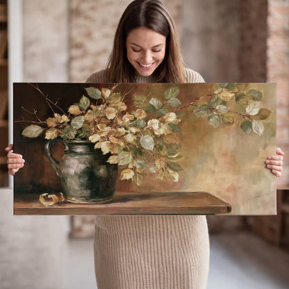 Pale golden blossoms and leaves in a dark green vase on a wooden ledge single canvas wall art held in hands