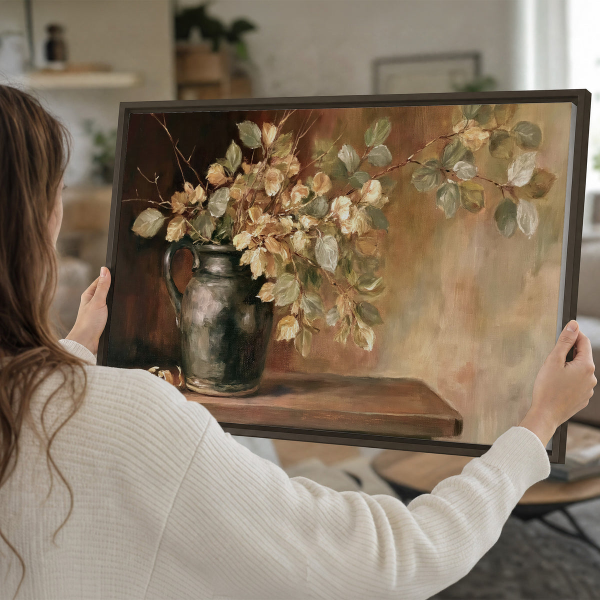 Pale golden blossoms and leaves in a dark green vase on a wooden ledge single framed canvas wall art held in hands