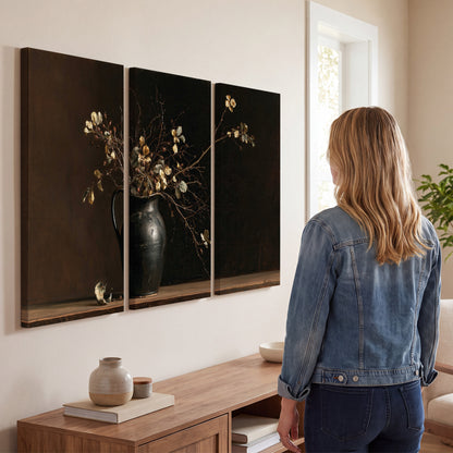 Fine flowering branches in a small dark vase on a wooden table against a deep brown background 3 piece canvas wall art three panel arrangement on a wall