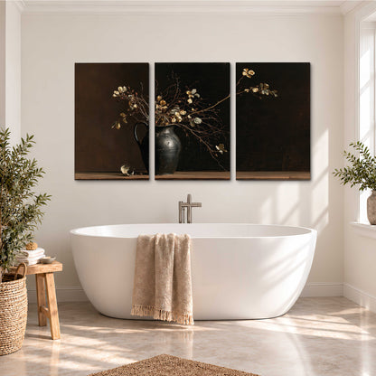 Fine flowering branches in a small dark vase on a wooden table against a deep brown background 3 piece canvas wall art styled in an interior