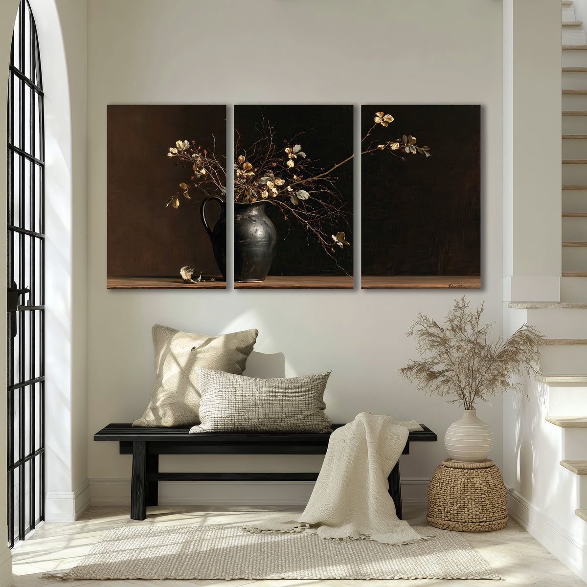 Fine flowering branches in a small dark vase on a wooden table against a deep brown background 3 piece canvas wall art displayed in a entryway