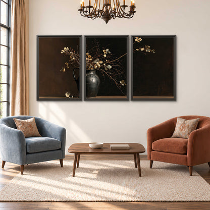 Fine flowering branches in a small dark vase on a wooden table against a deep brown background 3 piece framed canvas wall art styled in an interior
