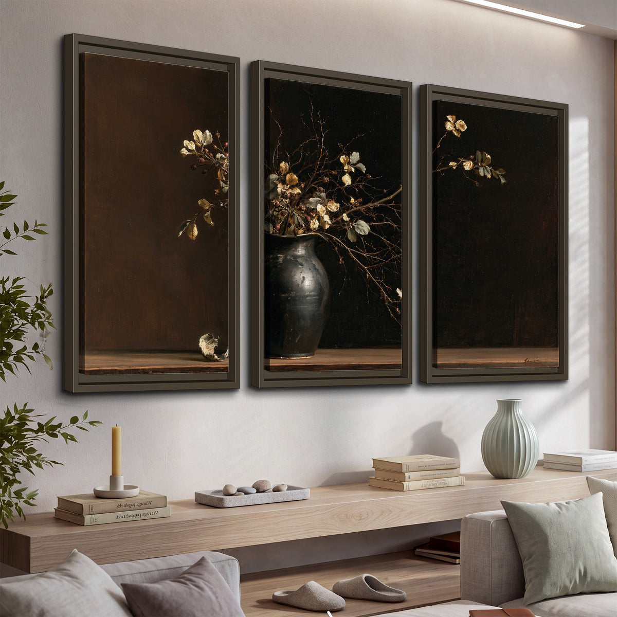 Fine flowering branches in a small dark vase on a wooden table against a deep brown background 3 piece framed canvas wall art displayed in a console