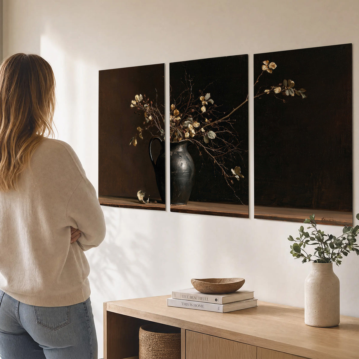 Fine flowering branches in a small dark vase on a wooden table against a deep brown background set of 3 poster prints three panel arrangement on a wall