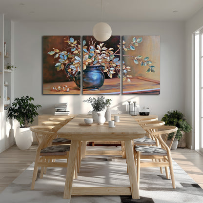 White and peach flowering branches arranged in a blue vase against a warm ochre background 3 piece canvas wall art room and product view
