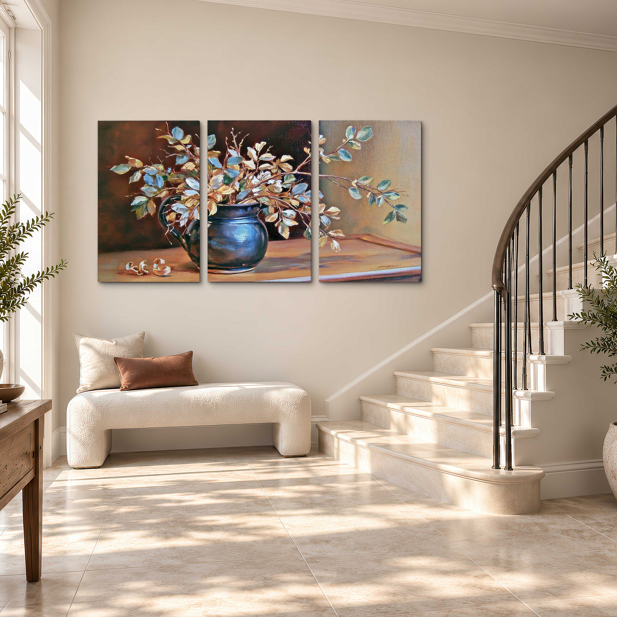 White and peach flowering branches arranged in a blue vase against a warm ochre background 3 piece canvas wall art styled in an interior