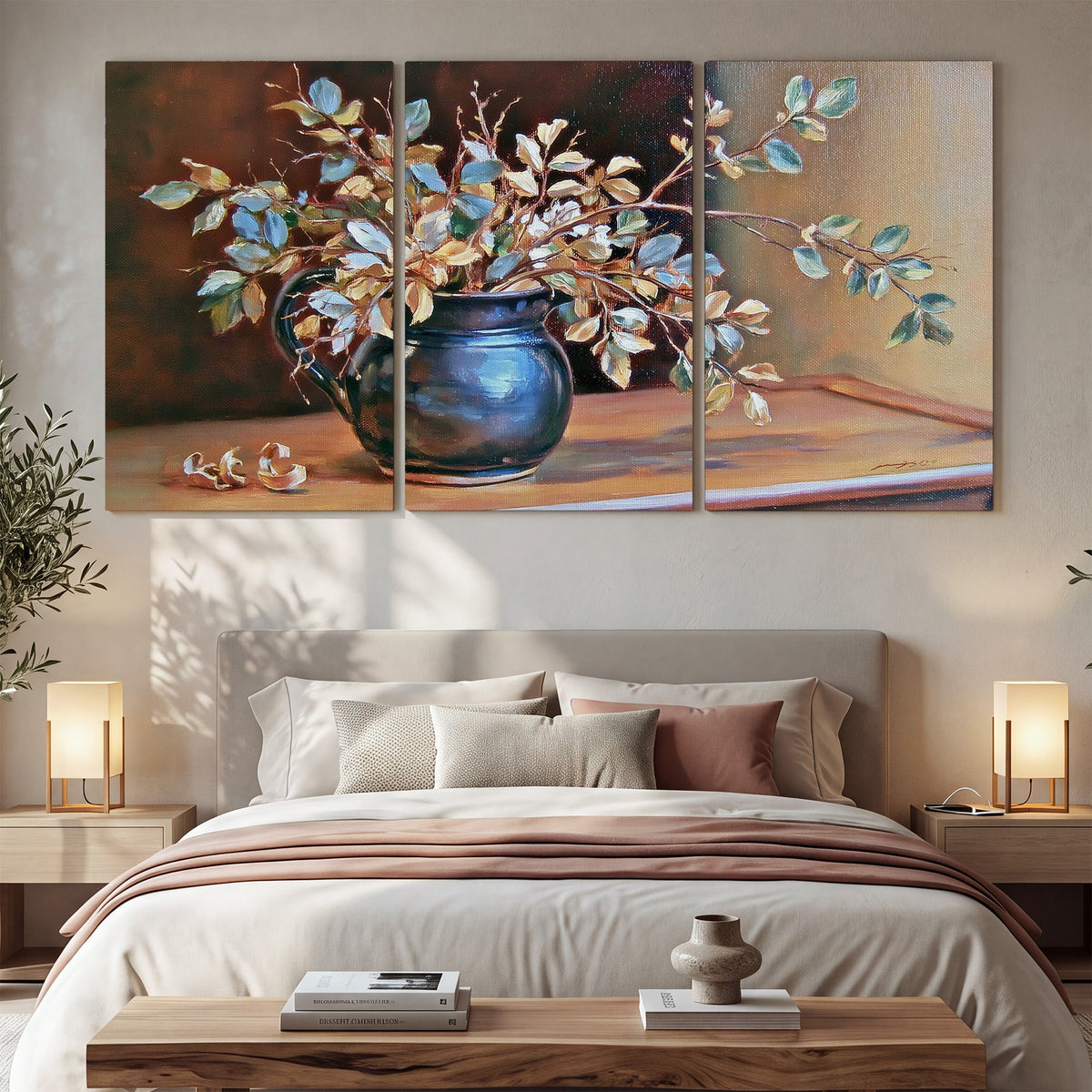 White and peach flowering branches arranged in a blue vase against a warm ochre background 3 piece canvas wall art displayed in a bedroom