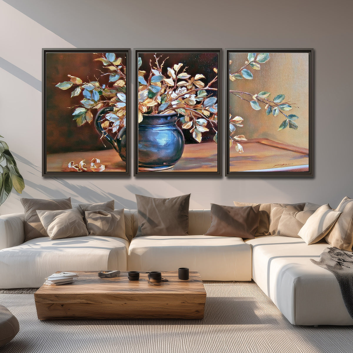 White and peach flowering branches arranged in a blue vase against a warm ochre background 3 piece framed canvas wall art displayed in a living room