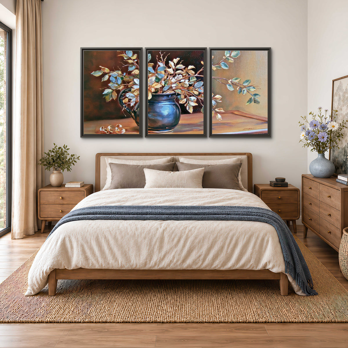 White and peach flowering branches arranged in a blue vase against a warm ochre background 3 piece framed canvas wall art styled in an interior