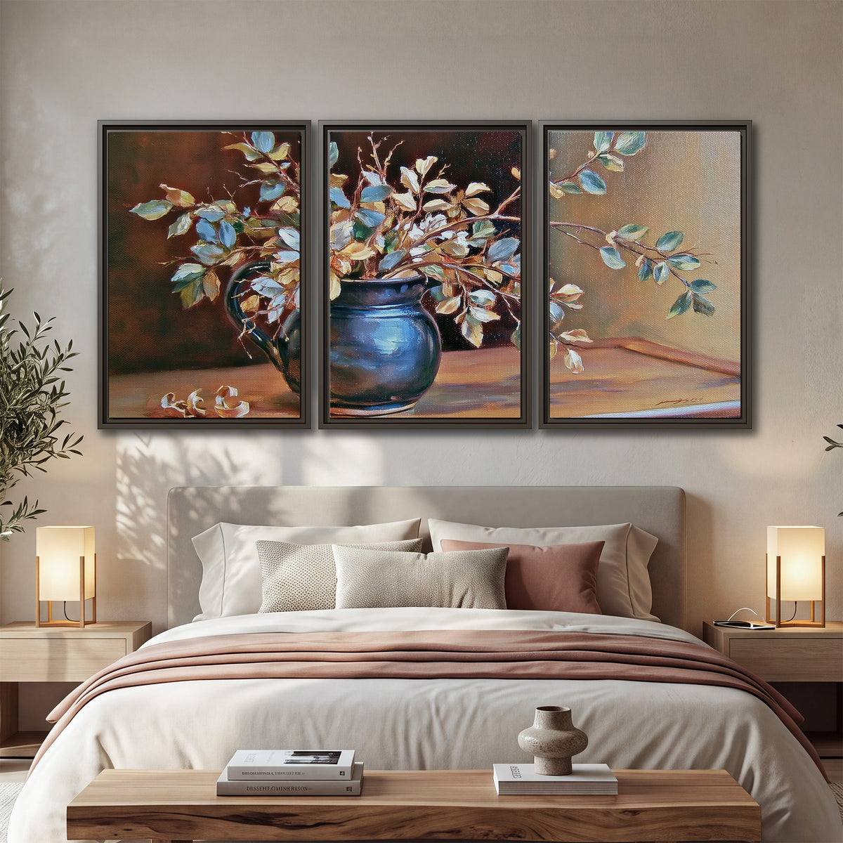 White and peach flowering branches arranged in a blue vase against a warm ochre background 3 piece framed canvas wall art displayed in a bedroom