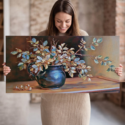 White and peach flowering branches arranged in a blue vase against a warm ochre background single canvas wall art held in hands