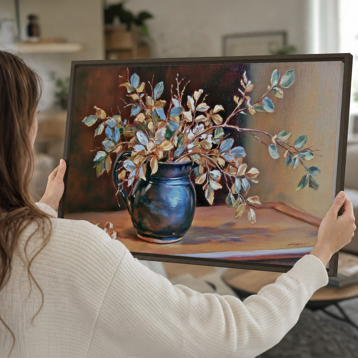 White and peach flowering branches arranged in a blue vase against a warm ochre background single framed canvas wall art held in hands