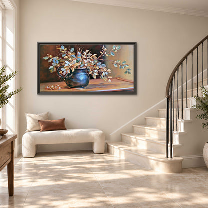 White and peach flowering branches arranged in a blue vase against a warm ochre background single framed canvas wall art styled in an interior