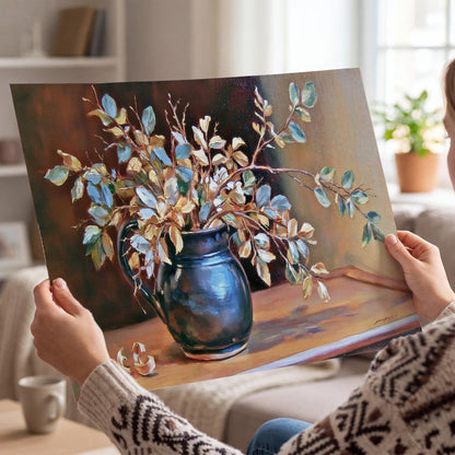 White and peach flowering branches arranged in a blue vase against a warm ochre background single poster print held in hands