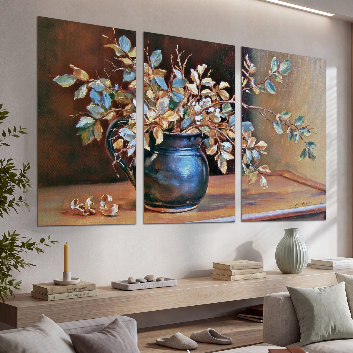 White and peach flowering branches arranged in a blue vase against a warm ochre background set of 3 poster prints displayed in a console
