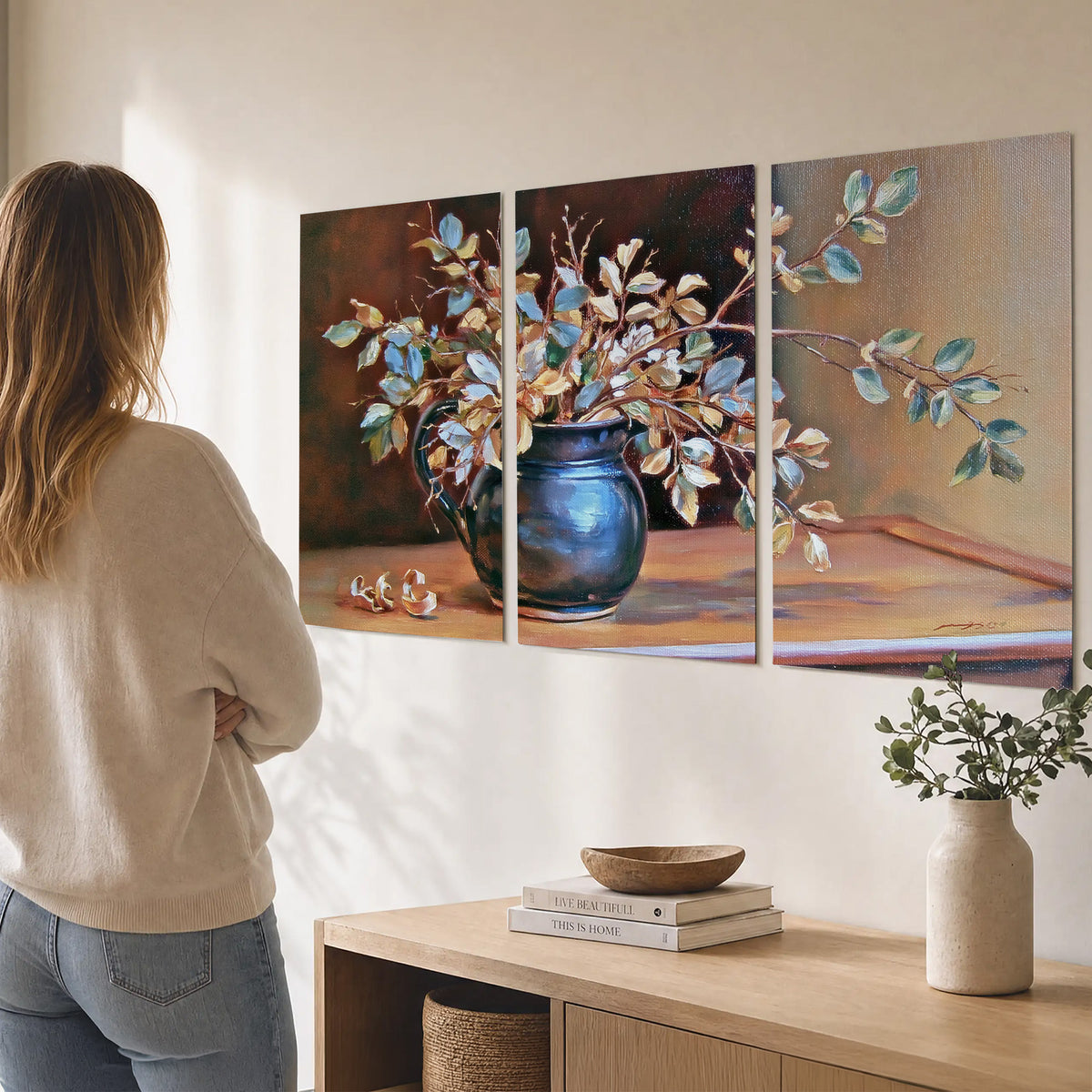 White and peach flowering branches arranged in a blue vase against a warm ochre background set of 3 poster prints three panel arrangement on a wall