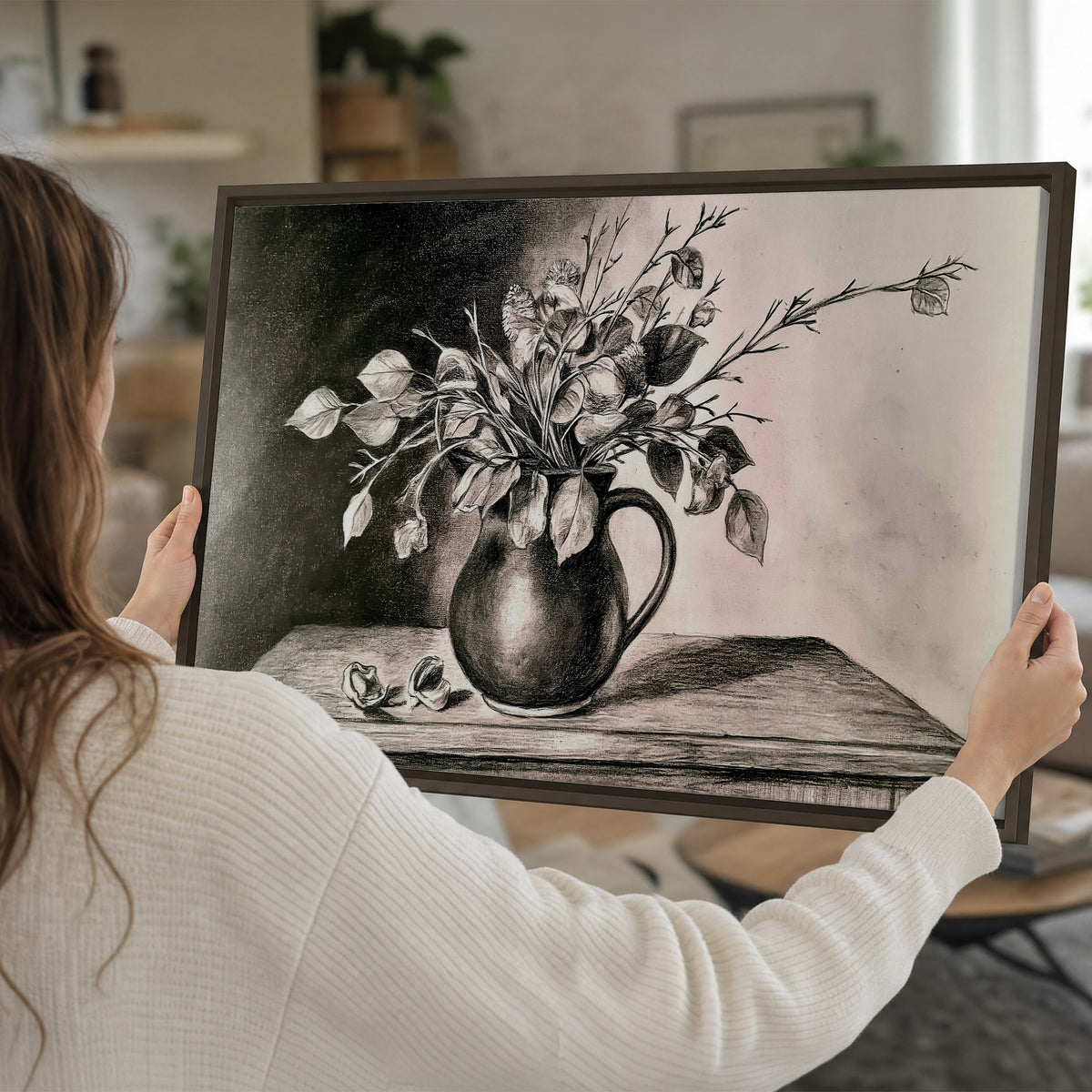 Leafy flowering branches in a rounded pitcher rendered in expressive charcoal-style strokes single framed canvas wall art held in hands