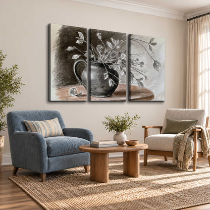 Fine leafy branches spilling from a dark rounded vase in a soft monochrome still life 3 piece canvas wall art styled in an interior