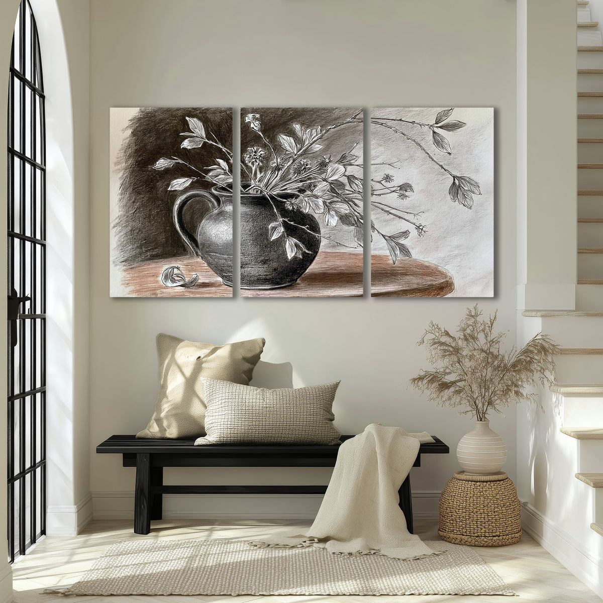 Fine leafy branches spilling from a dark rounded vase in a soft monochrome still life 3 piece canvas wall art displayed in a entryway
