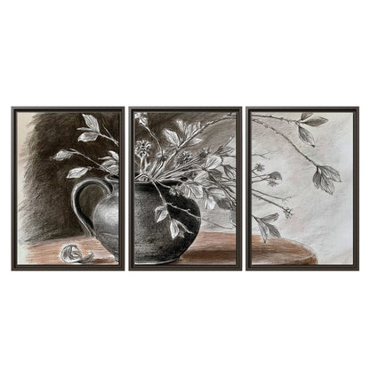 Fine leafy branches spilling from a dark rounded vase in a soft monochrome still life 3 piece framed canvas wall art viewed straight on