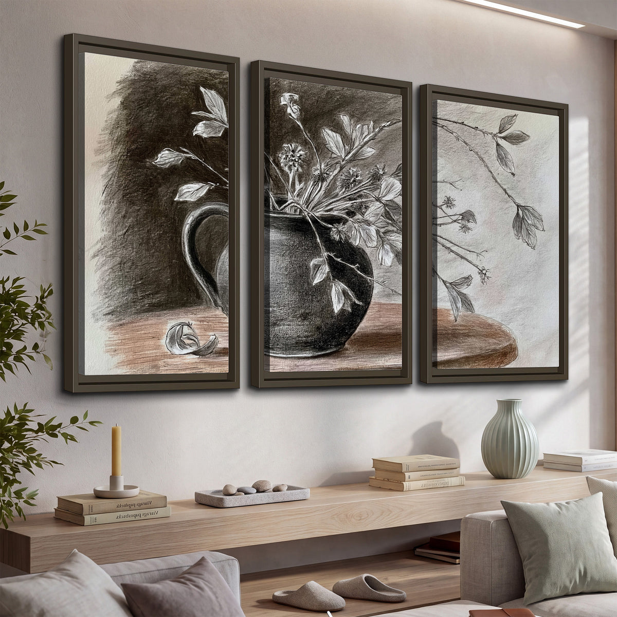 Fine leafy branches spilling from a dark rounded vase in a soft monochrome still life 3 piece framed canvas wall art displayed in a console