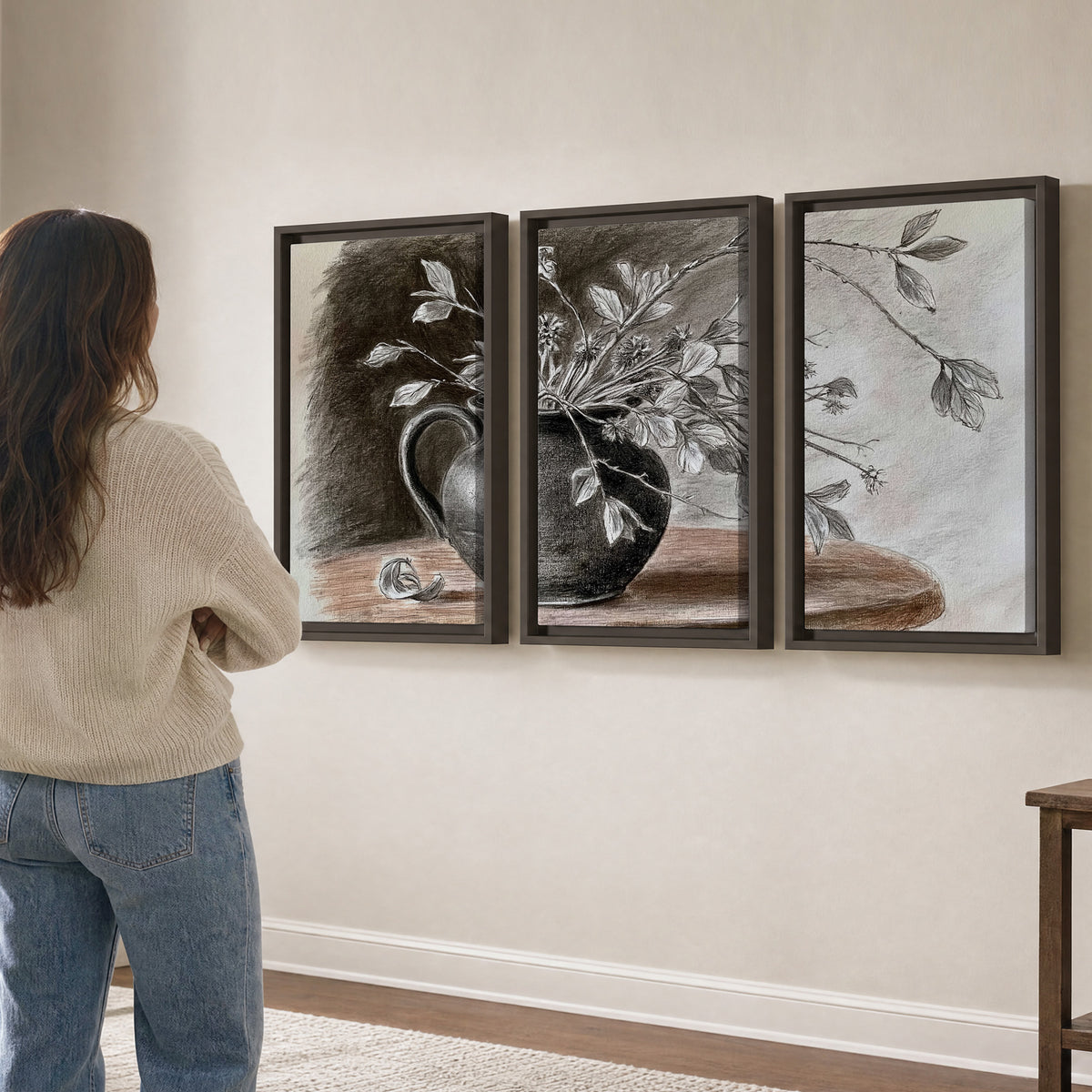 Fine leafy branches spilling from a dark rounded vase in a soft monochrome still life 3 piece framed canvas wall art three panel arrangement on a wall