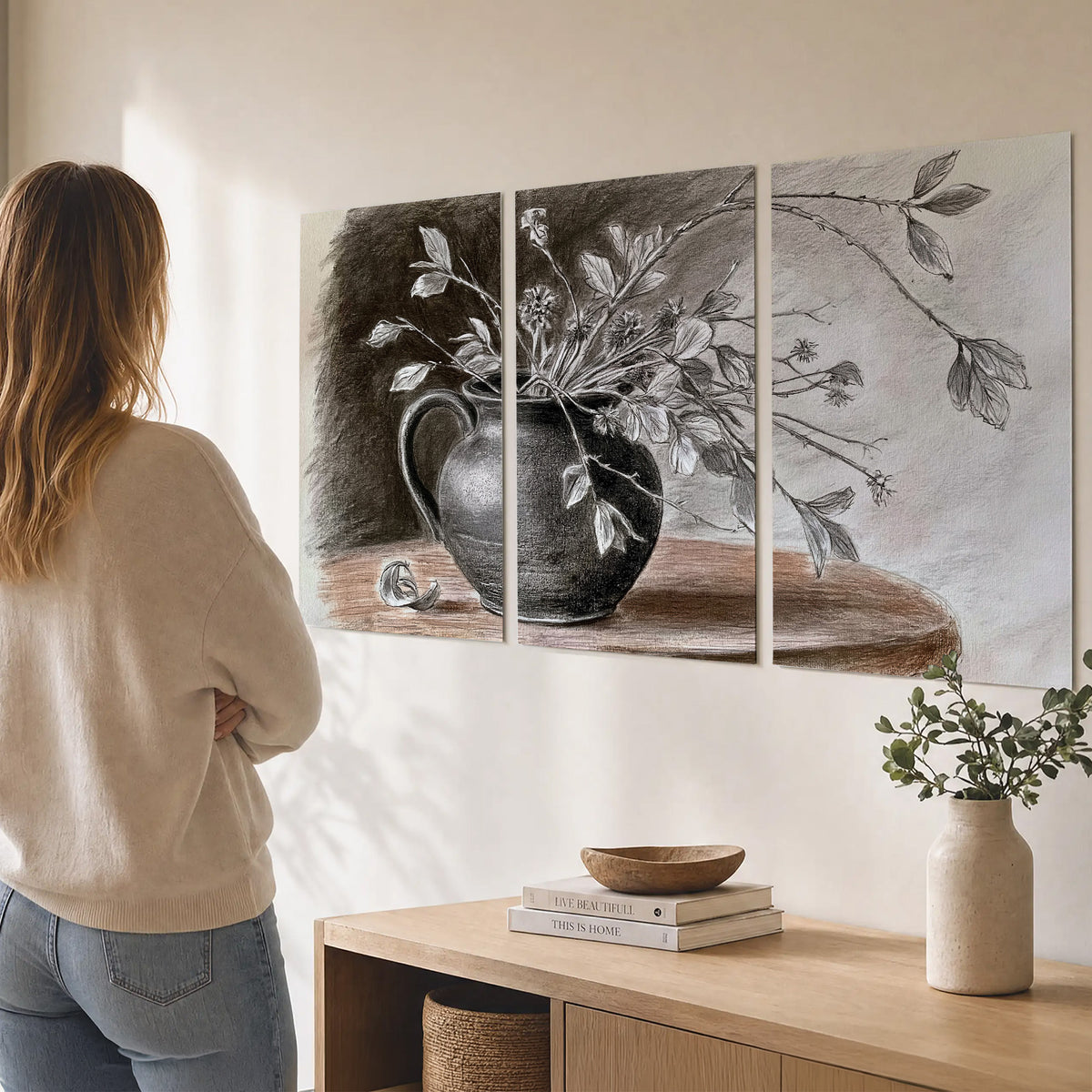 Fine leafy branches spilling from a dark rounded vase in a soft monochrome still life set of 3 poster prints three panel arrangement on a wall
