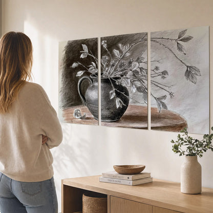 Fine leafy branches spilling from a dark rounded vase in a soft monochrome still life set of 3 poster prints three panel arrangement on a wall