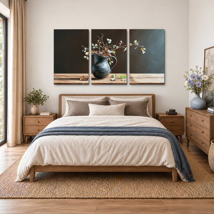 A delicate arrangement of pale blossoms in a blue vase on a sunlit wooden table 3 piece canvas wall art styled in an interior