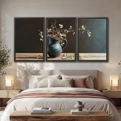 A delicate arrangement of pale blossoms in a blue vase on a sunlit wooden table 3 piece framed canvas wall art displayed in a bedroom