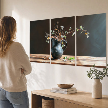 A delicate arrangement of pale blossoms in a blue vase on a sunlit wooden table set of 3 poster prints three panel arrangement on a wall