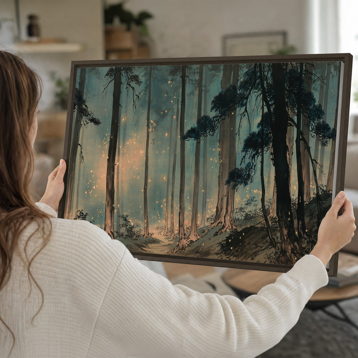 Warm shafts of light falling between tall dark pine trees in a misty green forest single framed canvas wall art held in hands