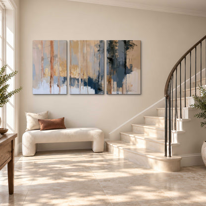 Vertical strokes of cream, blue and ochre suggesting a quiet woodland 3 piece canvas wall art styled in an interior