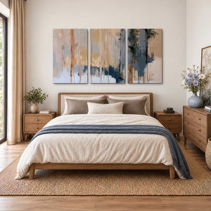 Vertical strokes of cream, blue and ochre suggesting a quiet woodland 3 piece canvas wall art styled in an interior