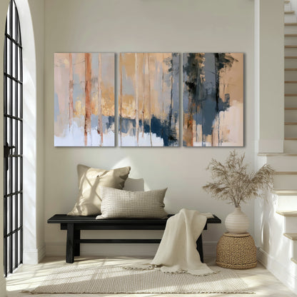 Vertical strokes of cream, blue and ochre suggesting a quiet woodland 3 piece canvas wall art displayed in a entryway
