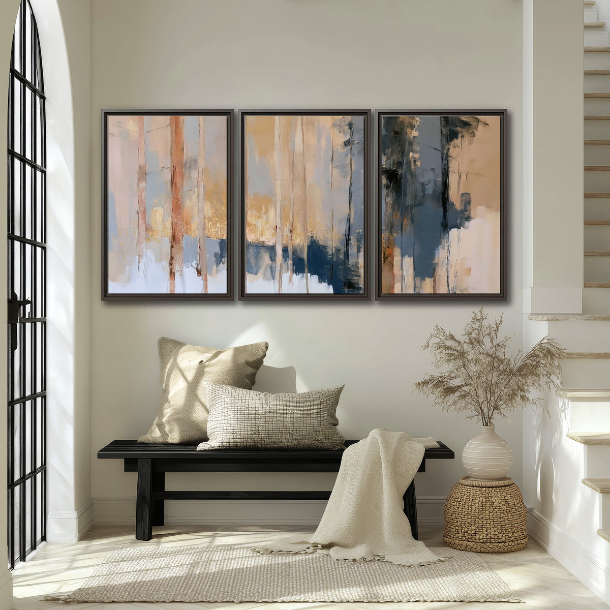 Vertical strokes of cream, blue and ochre suggesting a quiet woodland 3 piece framed canvas wall art displayed in a entryway