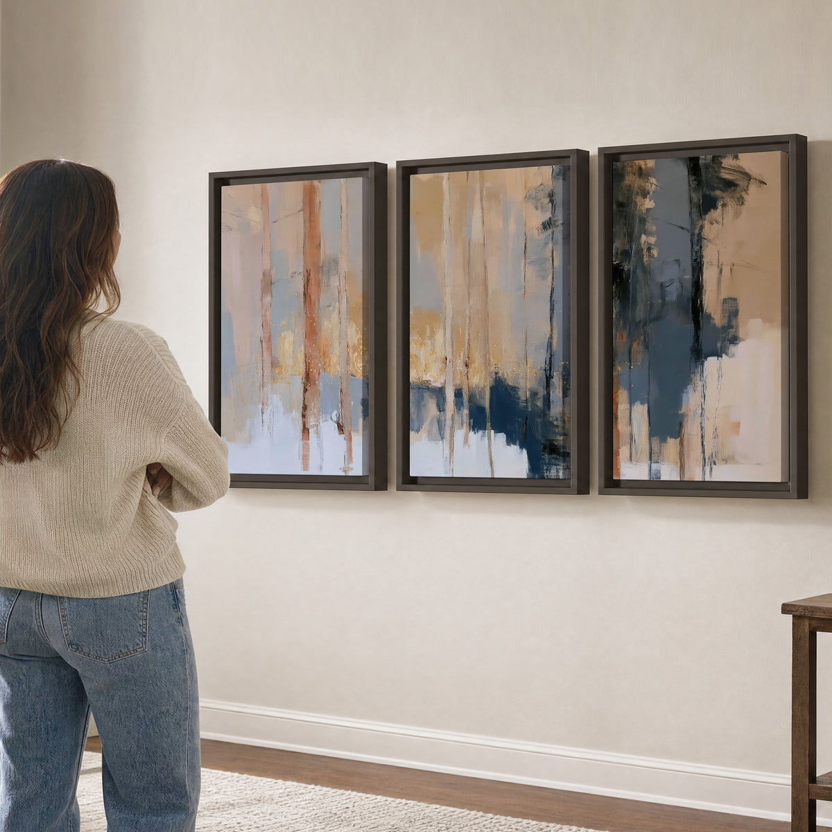 Vertical strokes of cream, blue and ochre suggesting a quiet woodland 3 piece framed canvas wall art three panel arrangement on a wall