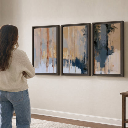 Vertical strokes of cream, blue and ochre suggesting a quiet woodland 3 piece framed canvas wall art three panel arrangement on a wall