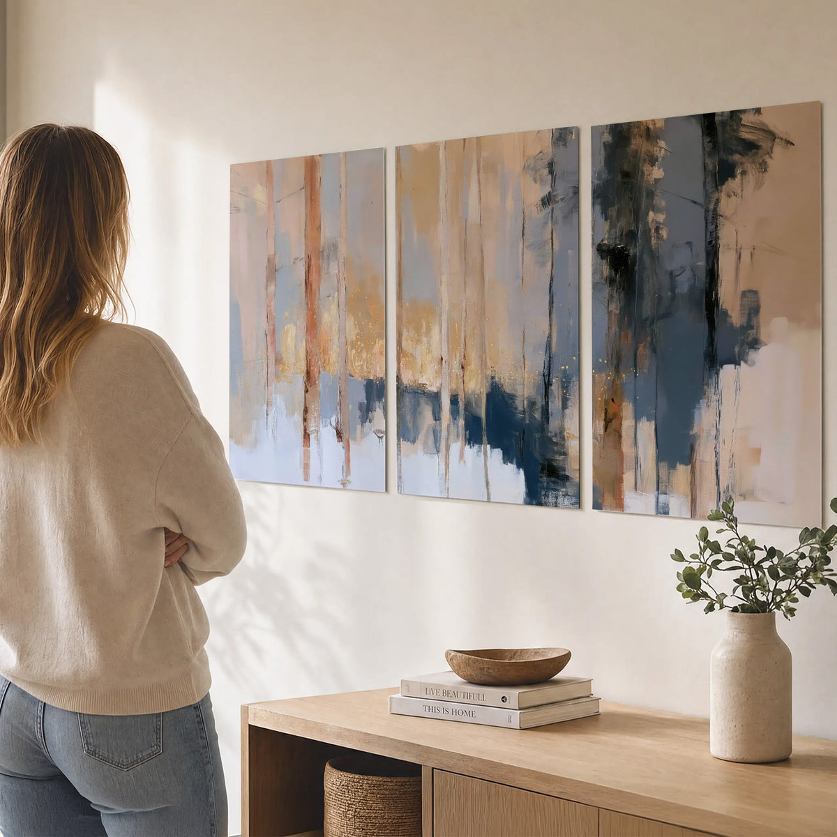Vertical strokes of cream, blue and ochre suggesting a quiet woodland set of 3 poster prints three panel arrangement on a wall